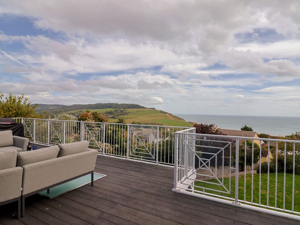 An outdoor area with seating and sea view at 13 Downside Close in Charmouth