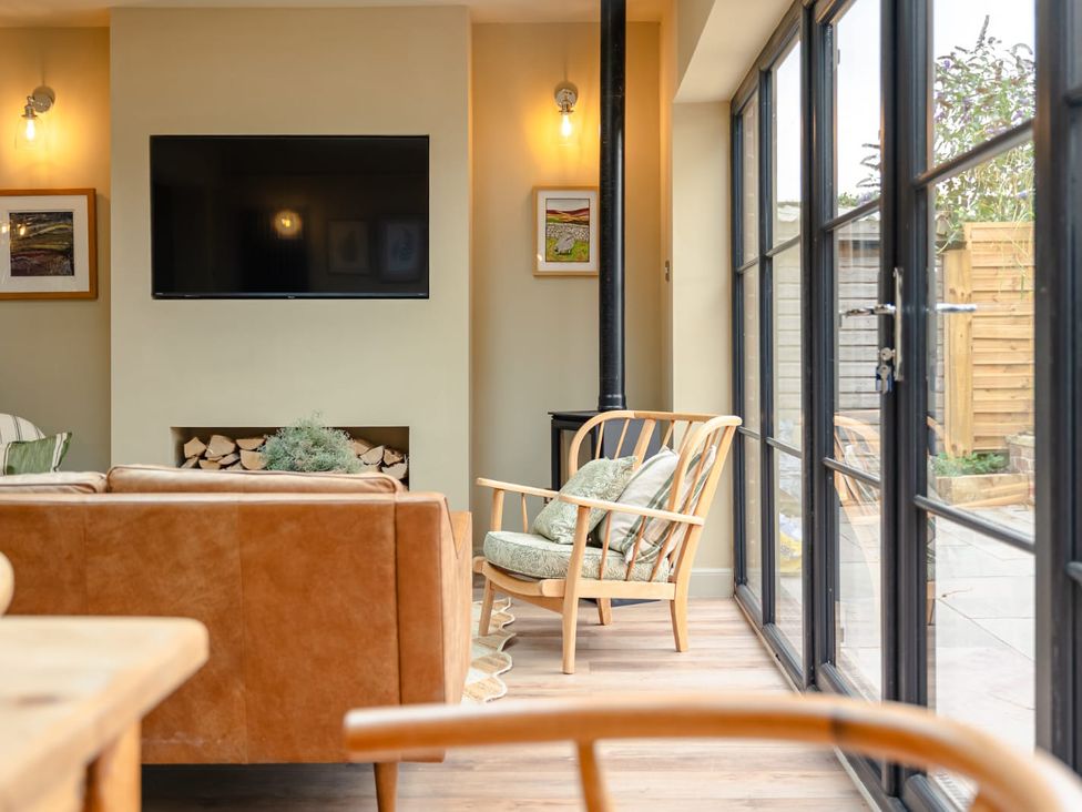 A living room with a television and sofa at 3 Olivers View in Brandsby