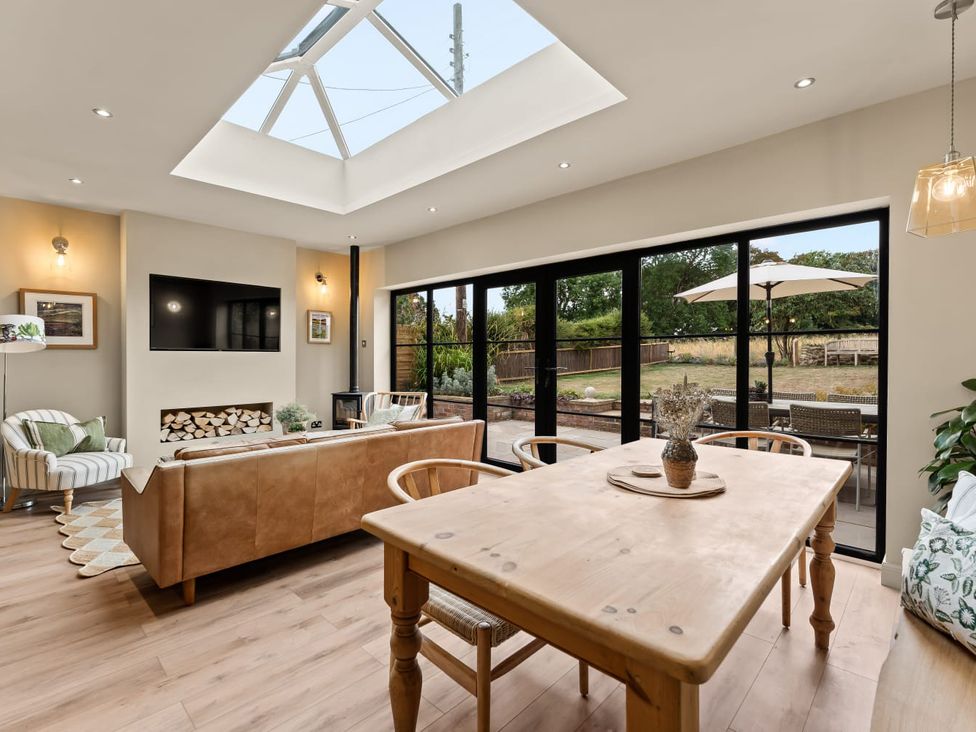 A living room with a sofa and dining table at 3 Olivers View in Brandsby