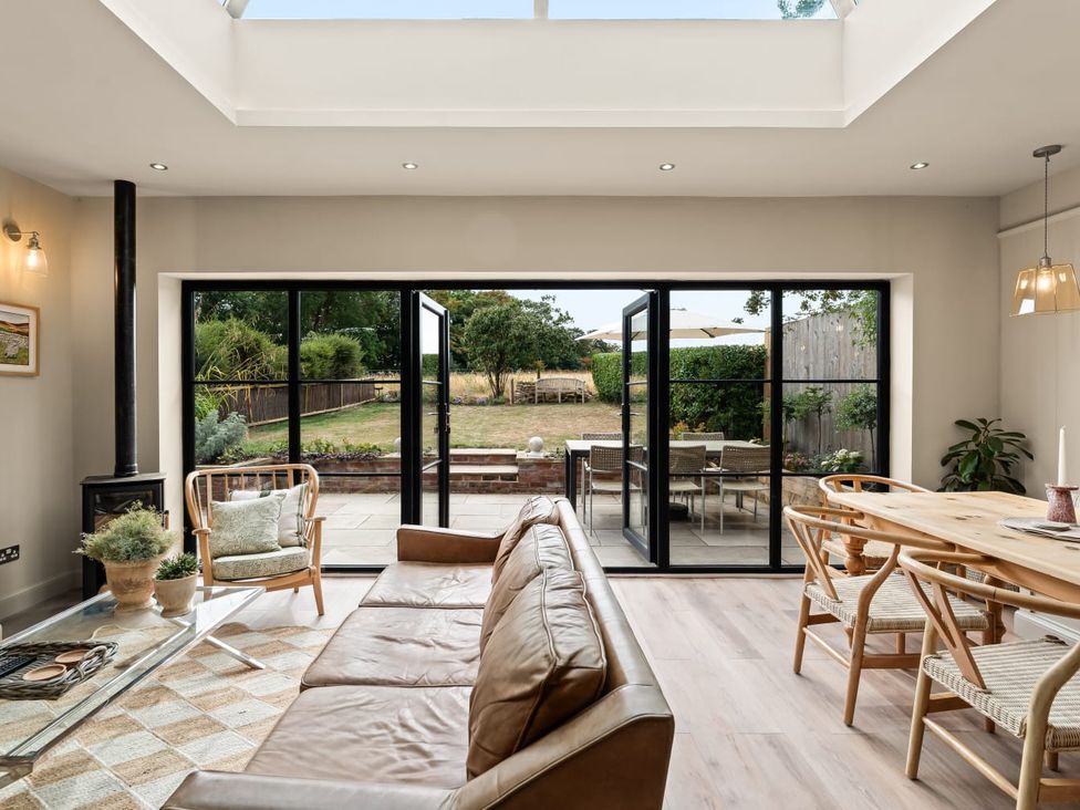A dining room with a glass door leading to the outdoor area at 3 Olivers View in Brandsby