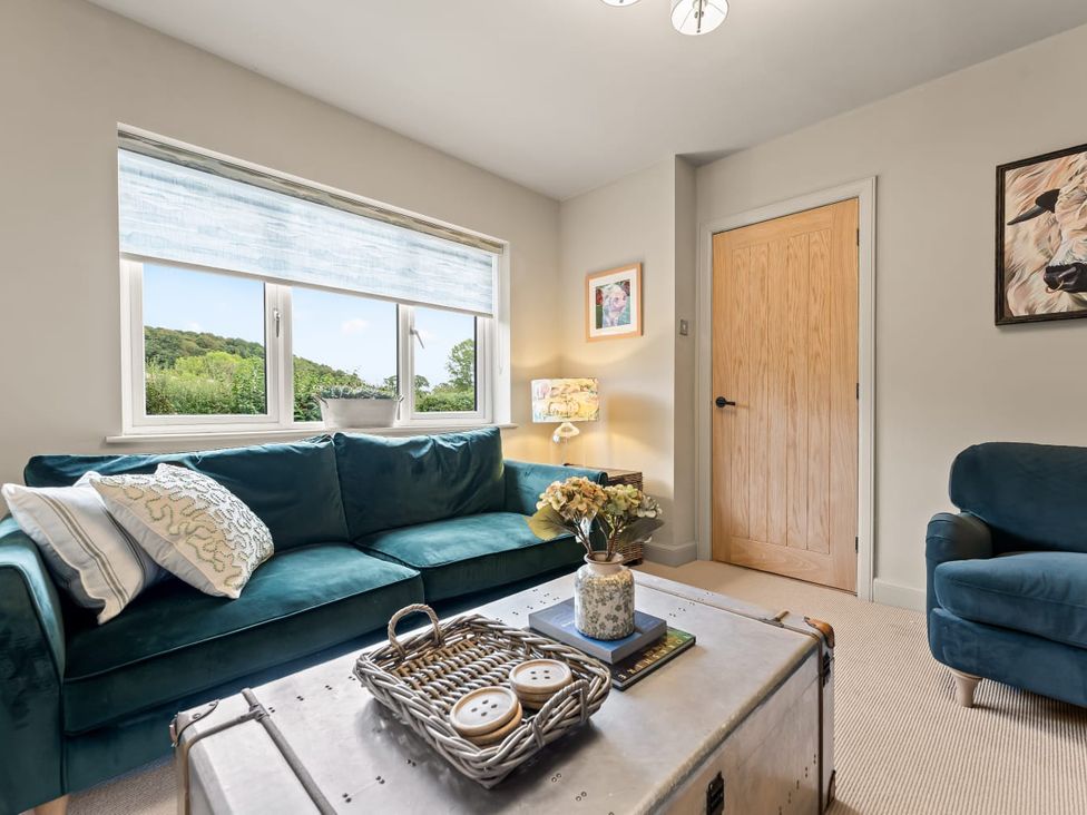 A living room with a sofa and coffee table at 3 Olivers View in Brandsby