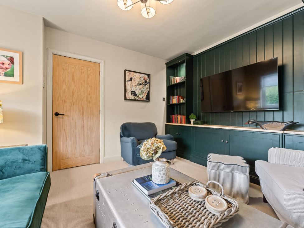 A living room with a television and a coffee table at 3 Olivers View in Brandsby