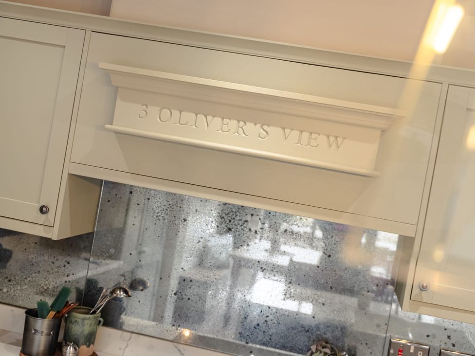 A kitchen with cabinets and a backsplash at 3 Olivers View in Brandsby