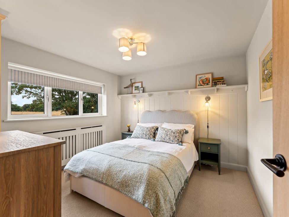 A bedroom with a bed and nightstand at 3 Olivers View in Brandsby