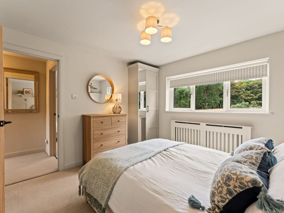 A bedroom with a bed and a window at 3 Olivers View in Brandsby
