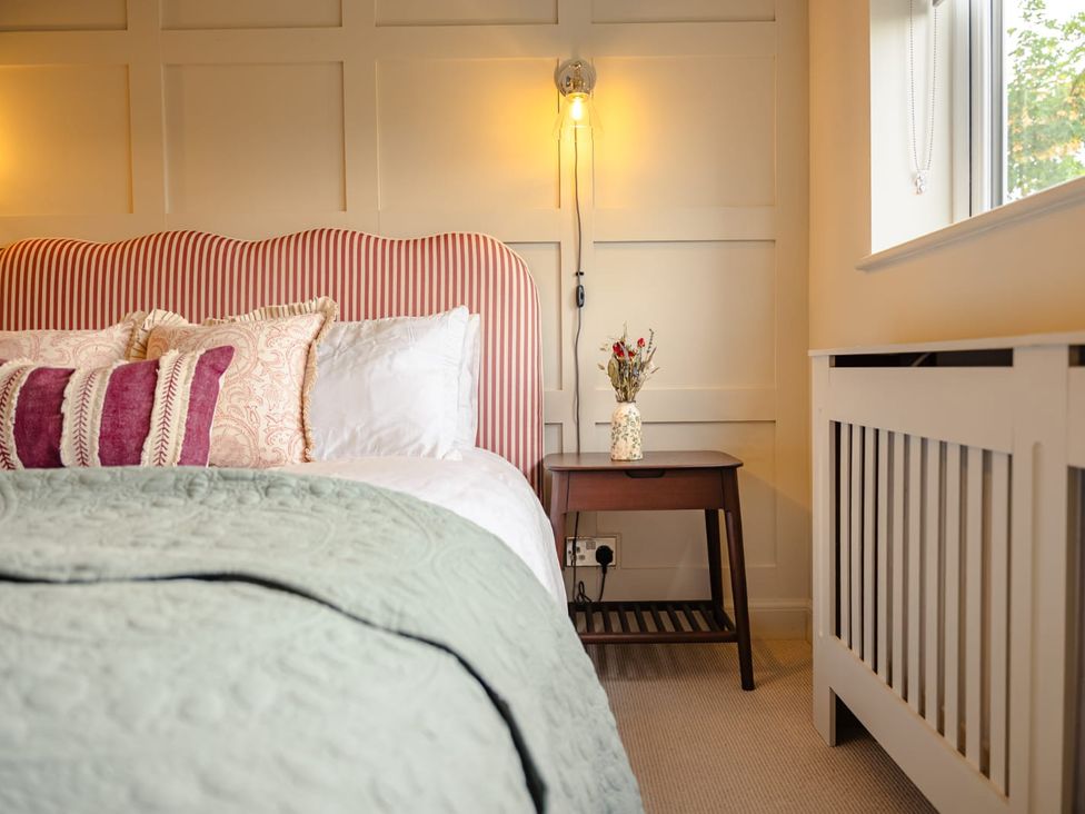 A bedroom with a bed and nightstand at 3 Olivers View in Brandsby