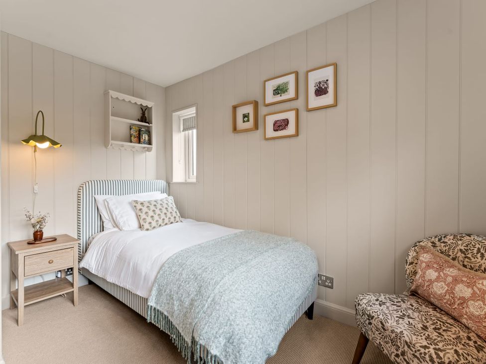 A bedroom with a single bed and wall art at 3 Olivers View in Brandsby