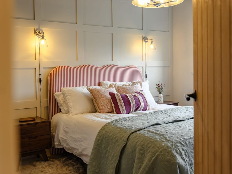 A bedroom with a bed and nightstand at 3 Olivers View Brandsby
