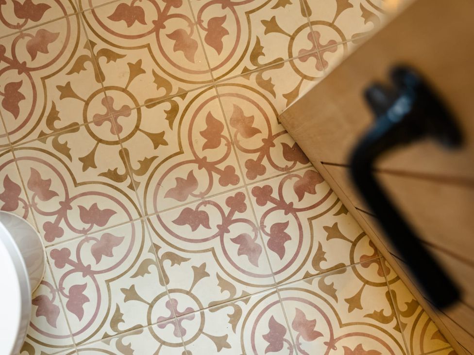 A bathroom floor with patterned tiles at 3 Olivers View in Brandsby