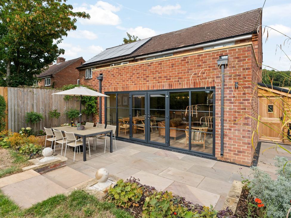 An outdoor dining area with a table and chairs at 3 Olivers View Brandsby