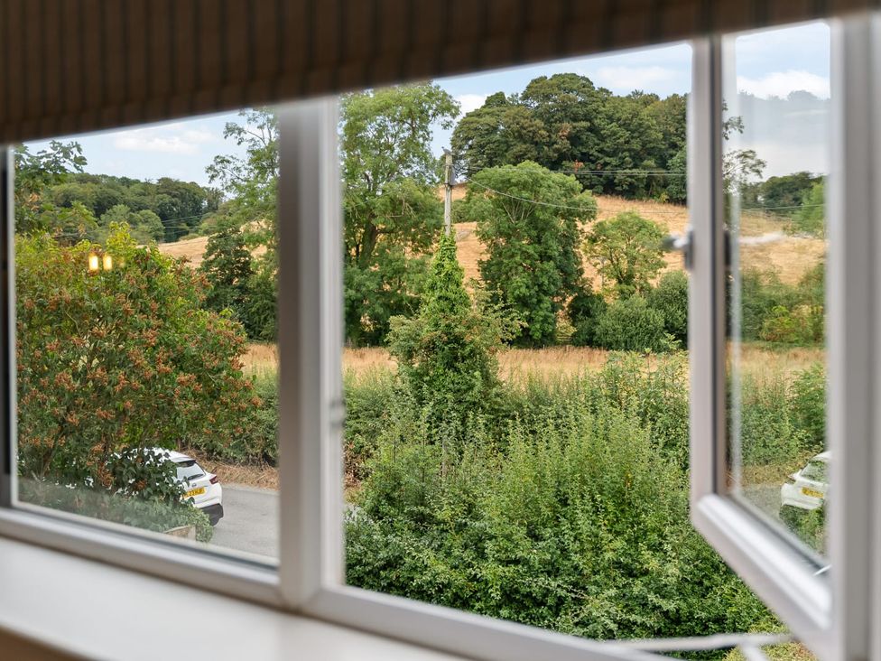 A view from a window showing trees and a field at 3 Olivers View Brandsby
