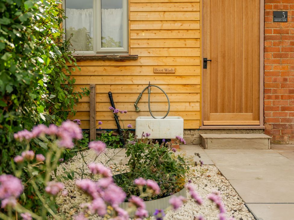 An exterior view of a boot wash and door at 3 Olivers View in Brandsby