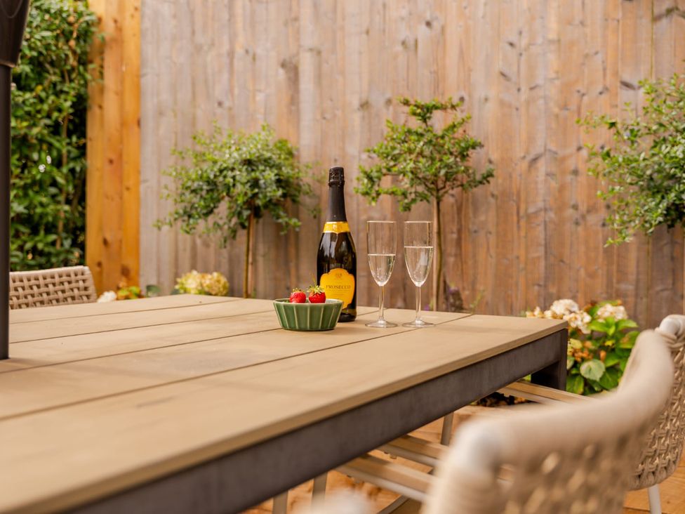 A table with champagne and glasses in an outdoor area at 3 Olivers View in Brandsby
