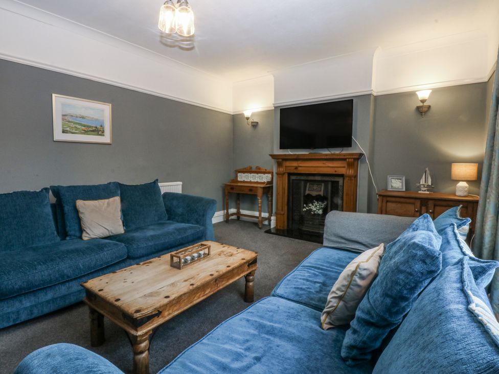 A living room with a fireplace and television at Penrhyn Arms Apartment in Llandudno