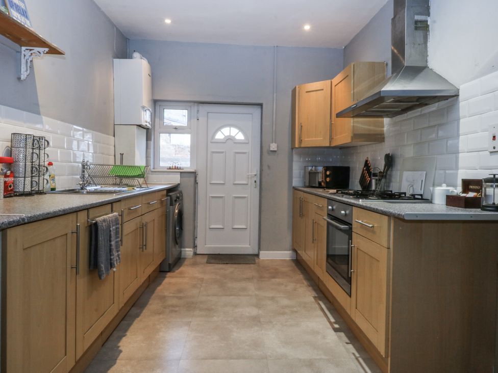 A kitchen with appliances and sink at Penrhyn Arms Apartment Llandudno