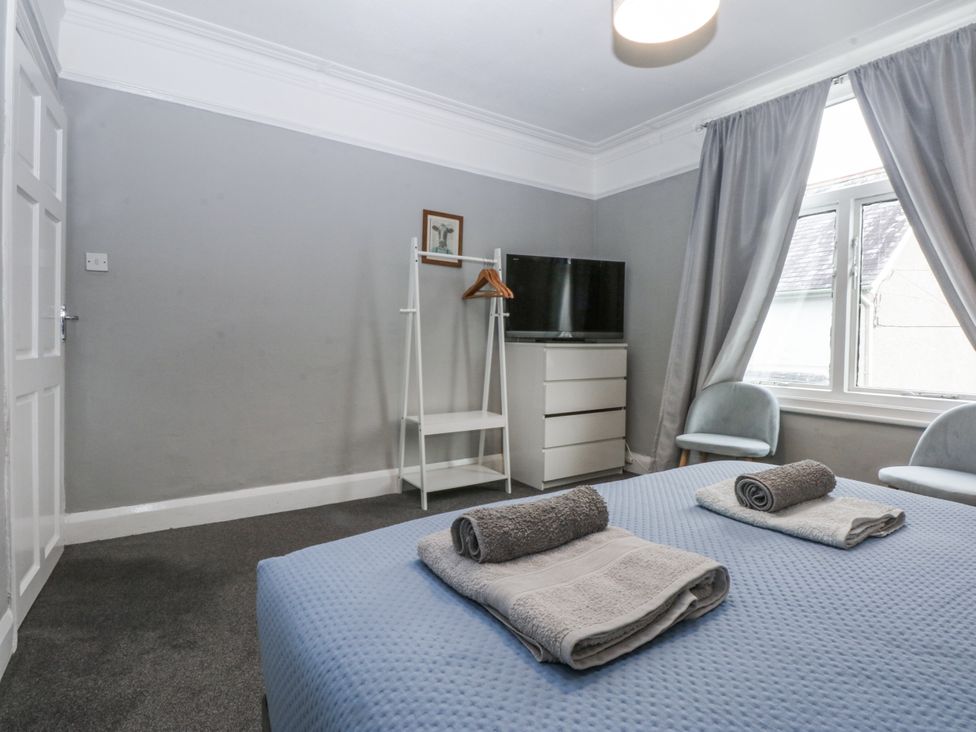 A bedroom with a bed and towels on it at Penrhyn Arms Apartment in Llandudno
