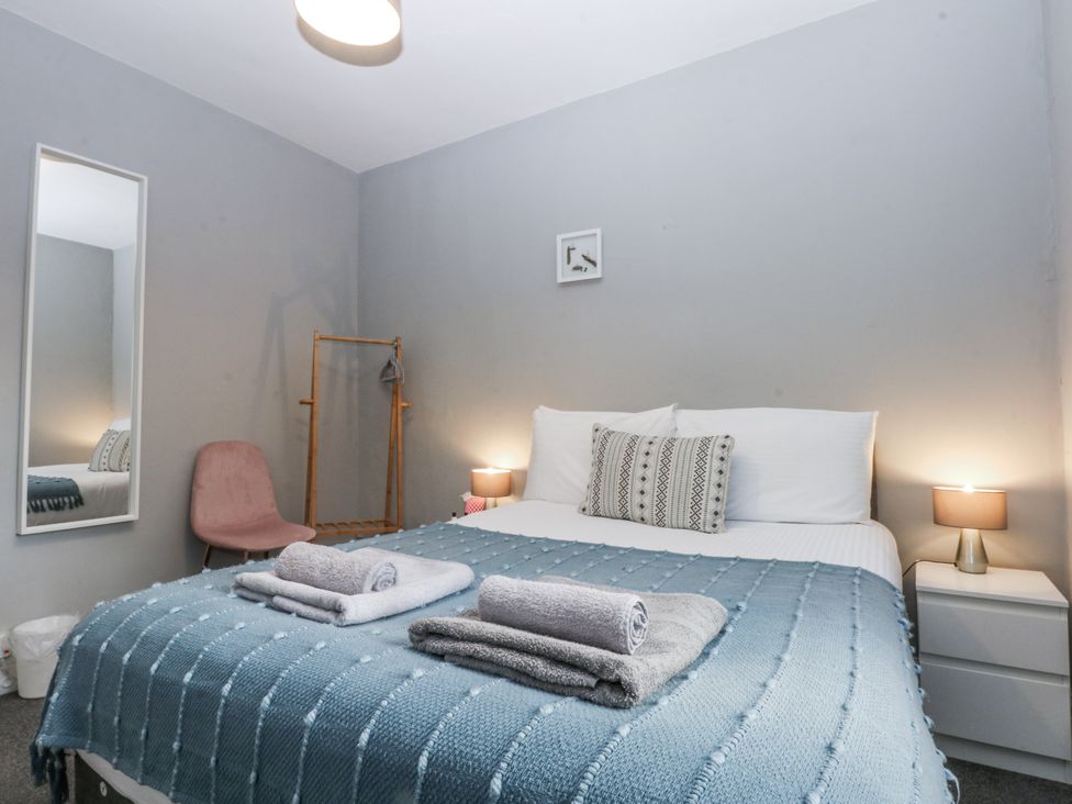 A bedroom with bed and bedside tables at Penrhyn Arms Apartment Llandudno