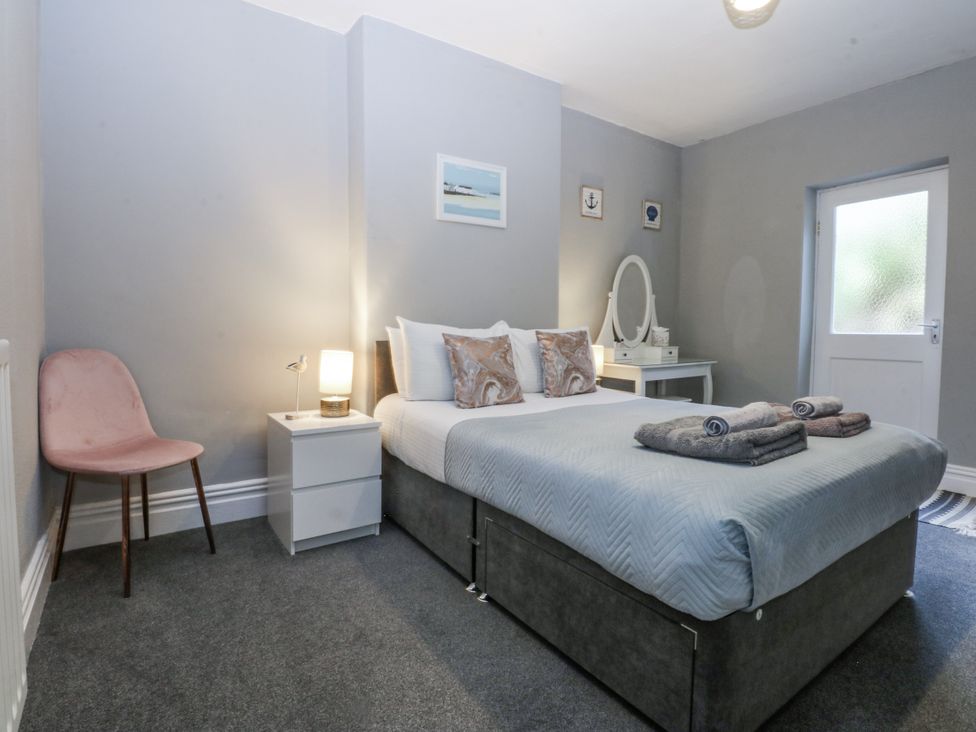 A bedroom with a bed and nightstand at Penrhyn Arms Apartment Llandudno