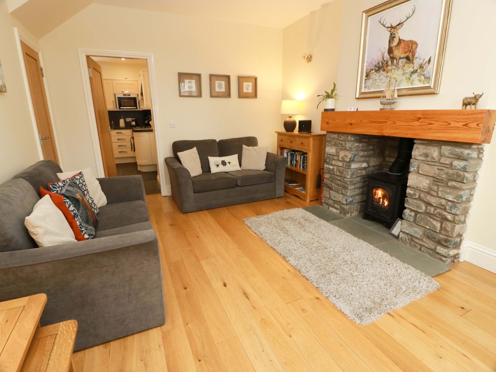 A living room with seating and a fireplace at Haven Cottage in Kirkcudbright