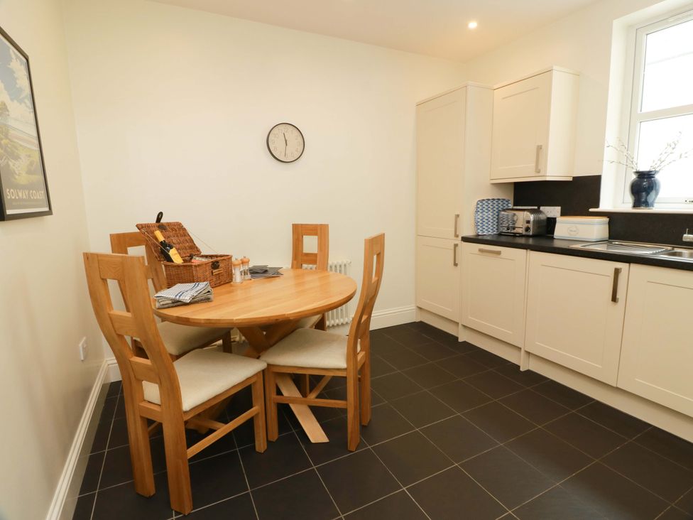 A kitchen with a round table and chairs at Haven Cottage in Kirkcudbright