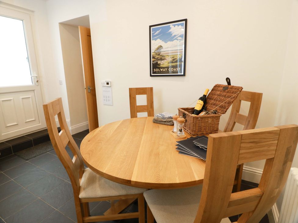 A dining room with wooden table and chairs at Haven Cottage in Kirkcudbright