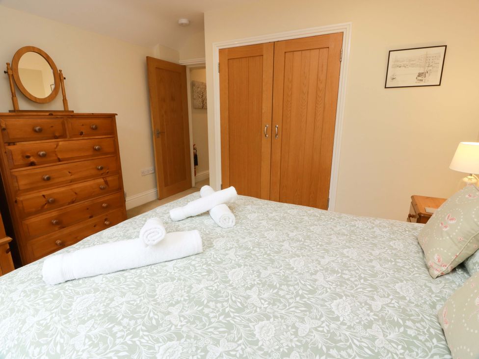 A bedroom with a bed and a chest of drawers at Haven Cottage in Kirkcudbright