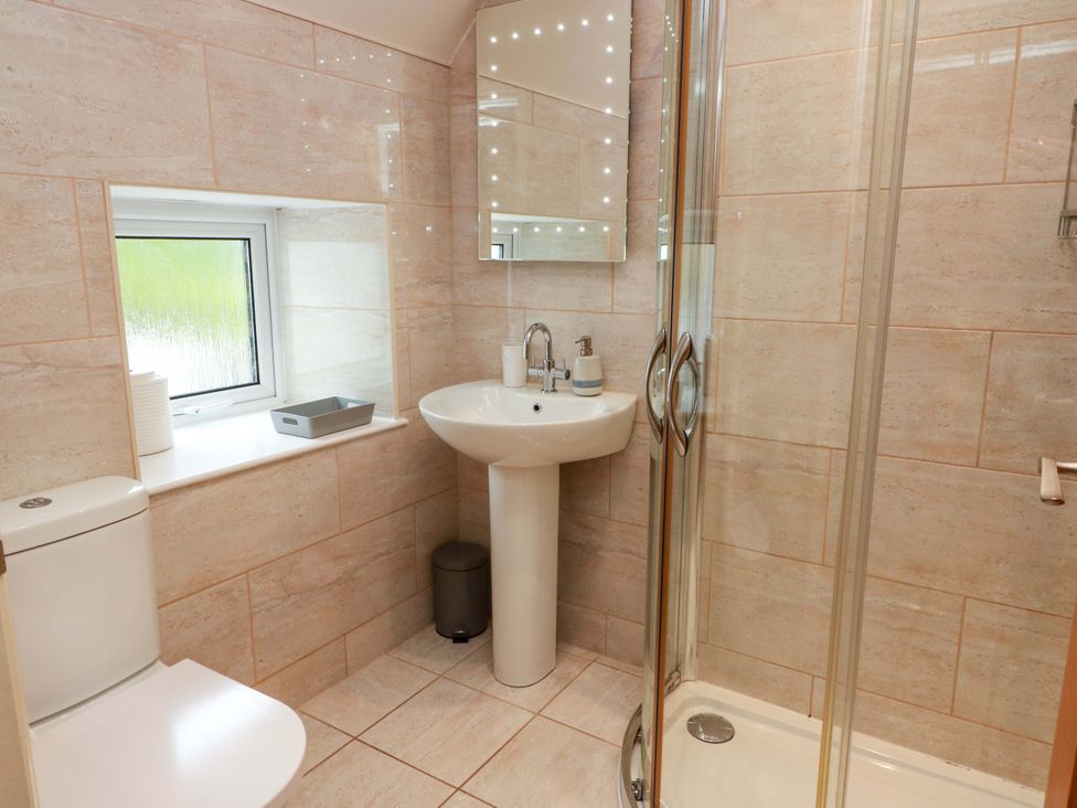 A bathroom with a shower and sink at Haven Cottage in Kirkcudbright