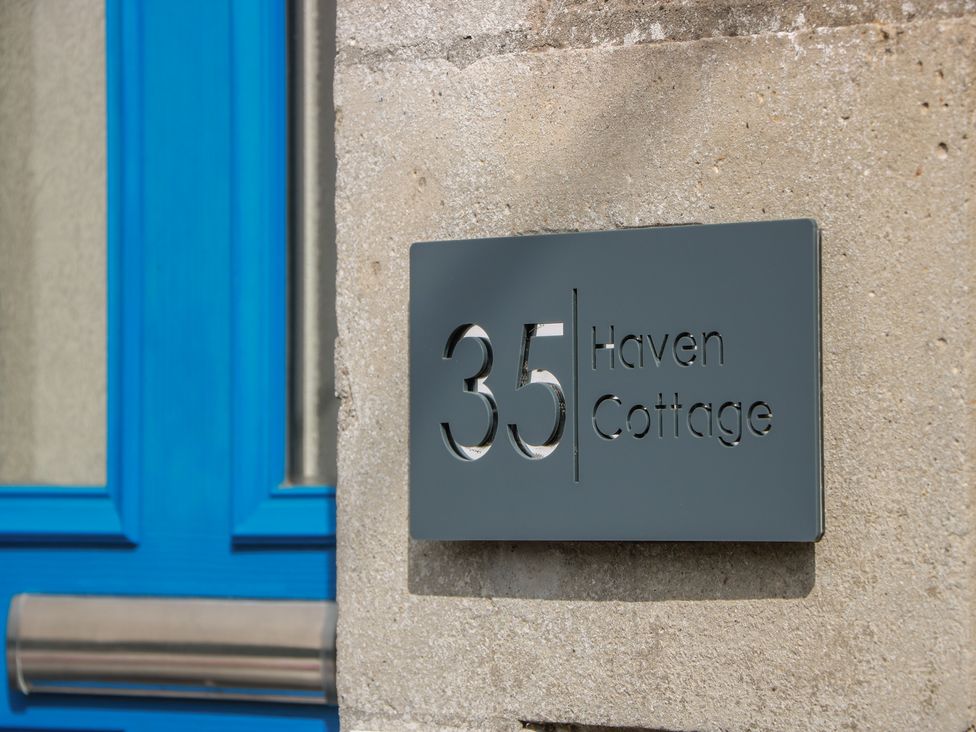 A nameplate displaying the number 35 and the name Haven Cottage
