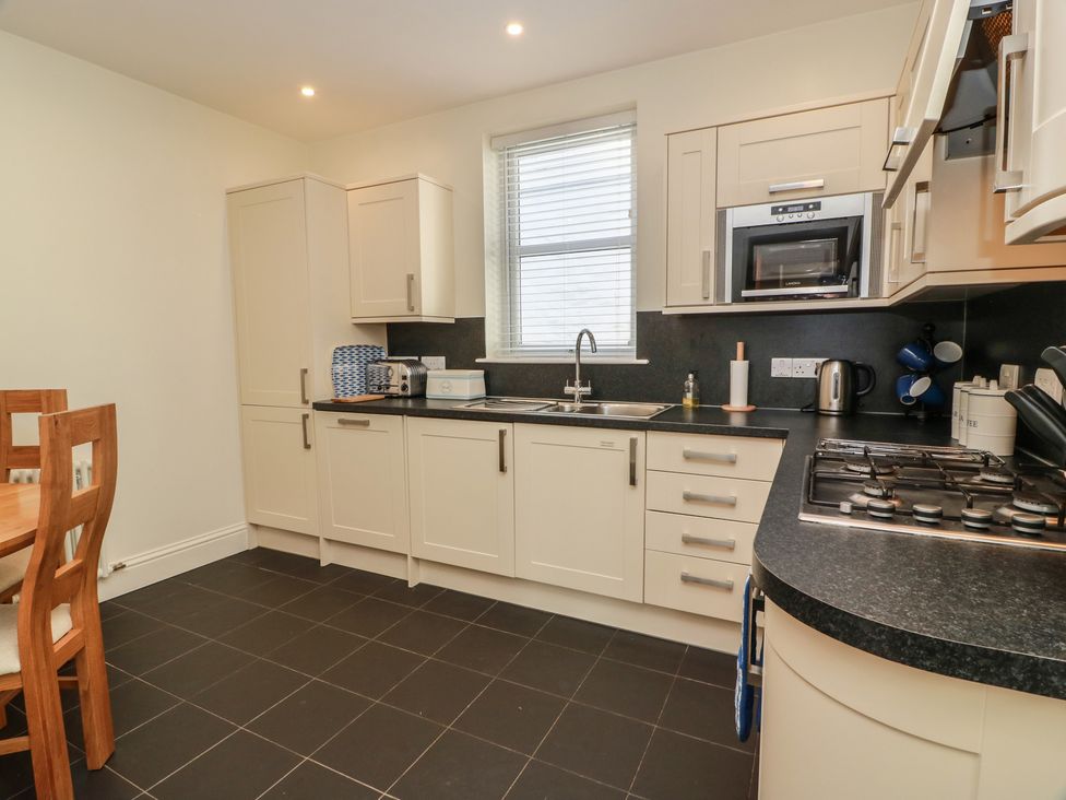 A kitchen with cabinets and a sink at Haven Cottage in Kirkcudbright