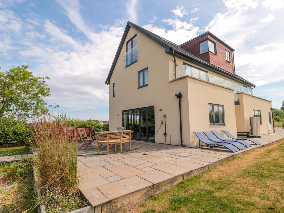 A house with a patio and sun loungers at Station House in Bason Bridge near Highbridge