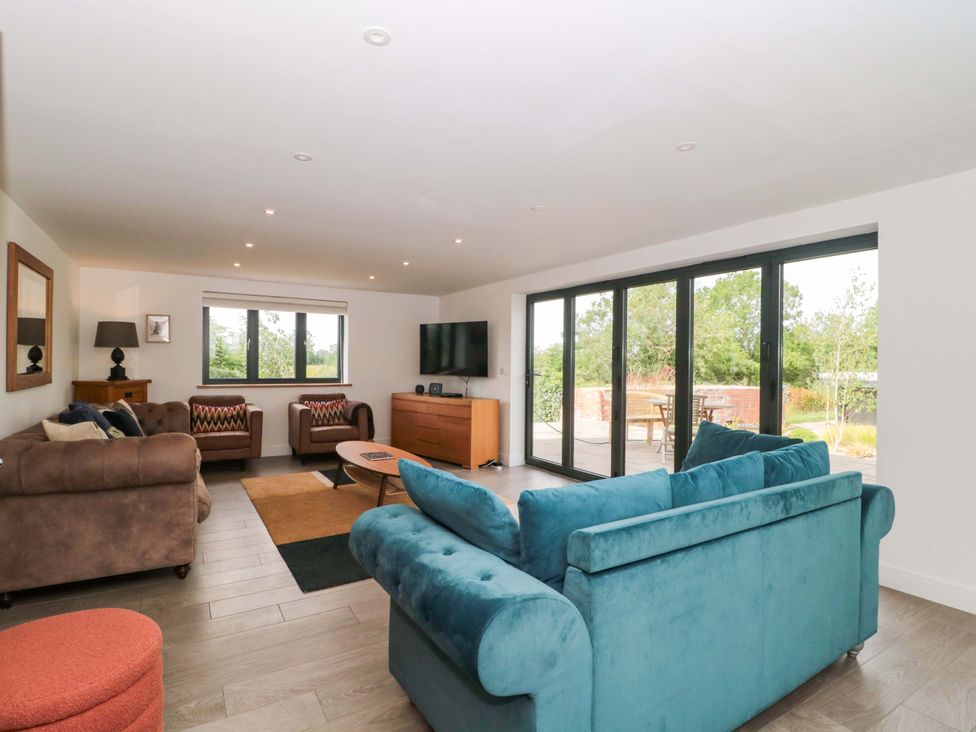 A living room with a sofa and coffee table at Station House Bason Bridge near Highbridge