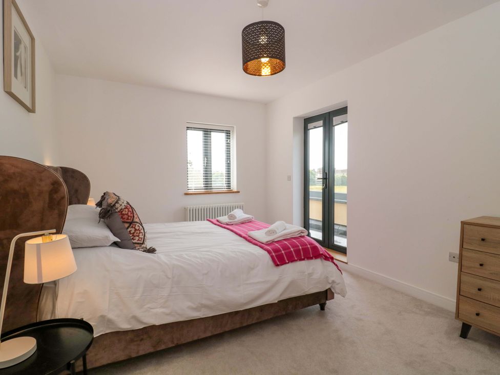 A bedroom with a bed and dresser at Station House Bason Bridge near Highbridge