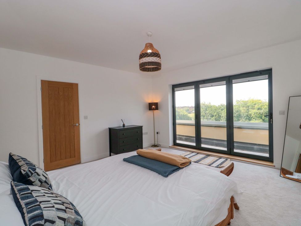 A bedroom with a bed and dresser at Station House in Bason Bridge near Highbridge