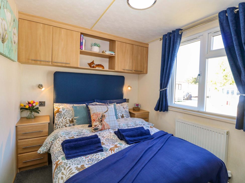 A bedroom with a bed and shelving at 25 Foxburrow Hang in Fritton near Belton