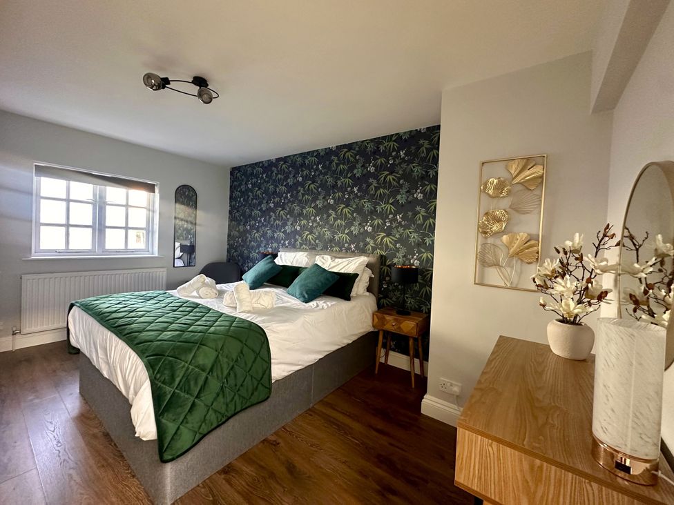 A bedroom with a bed and nightstand at Melanie's Cottage in Brewers Quay Harbour