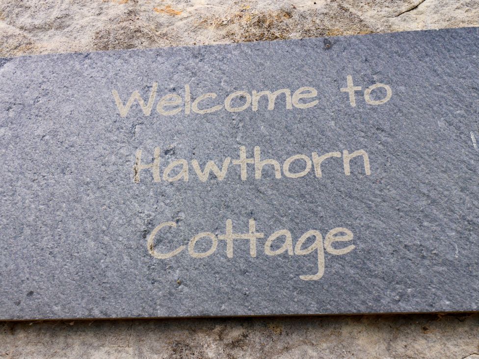 A slate sign with Welcome to Hawthorn Cottage in Silpho near Scalby