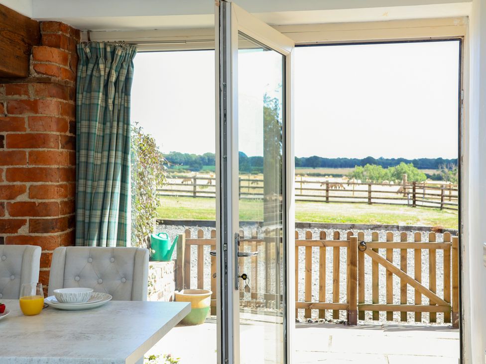 A dining room with a table and chairs at Hawthorn Cottage Silpho near Scalby