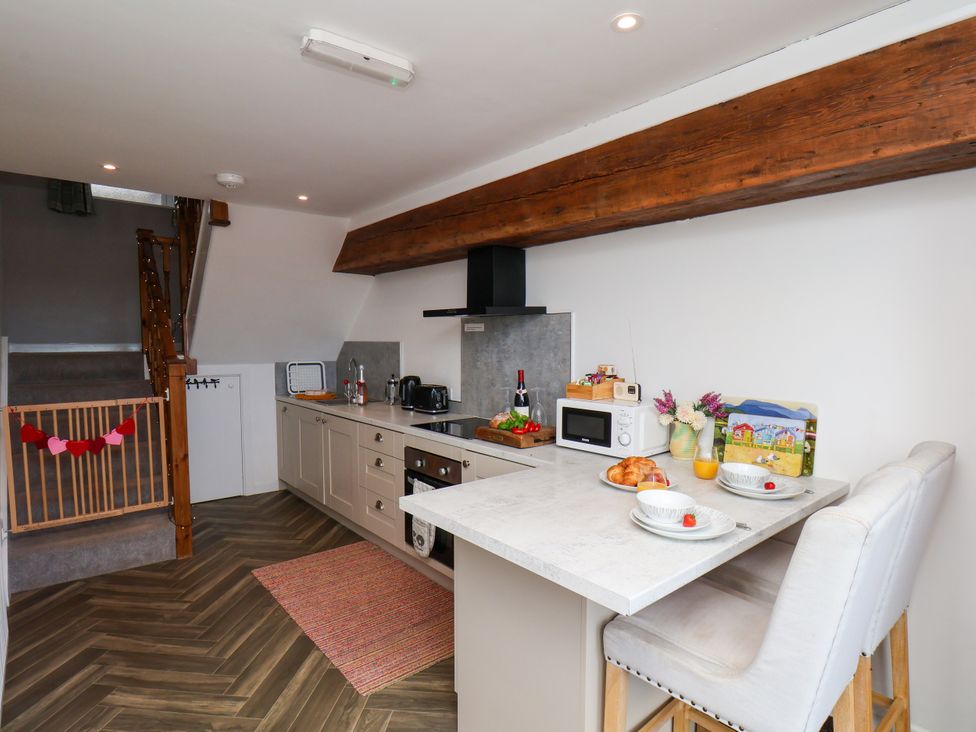 A kitchen with a table and stools at Hawthorn Cottage Silpho near Scalby