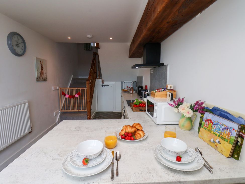 A kitchen with dining table and breakfast items at Hawthorn Cottage in Silpho near Scalby