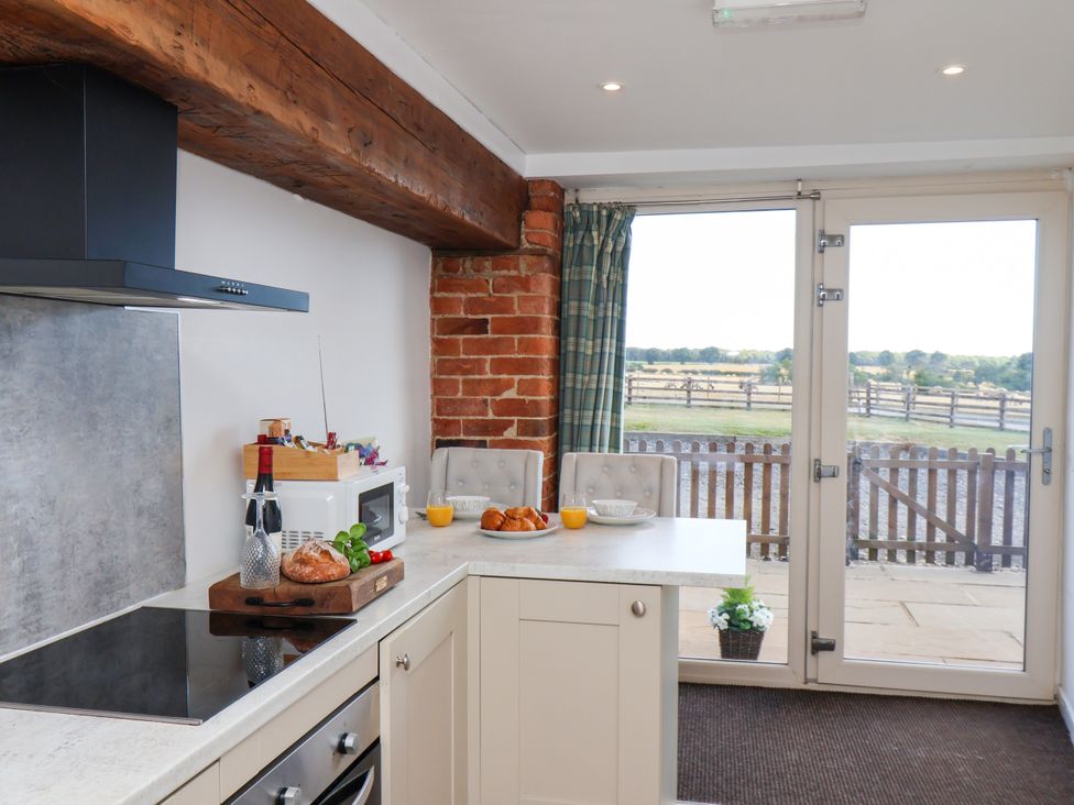 A kitchen with a countertop and dining seating at Hawthorn Cottage, Silpho near Scalby