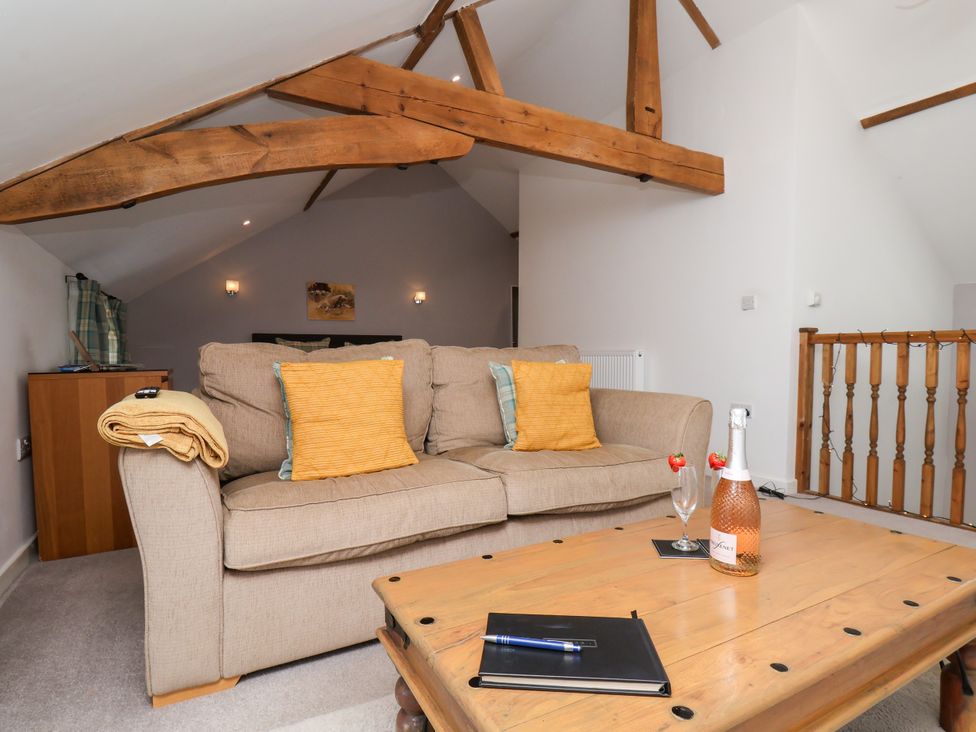 A living room with a sofa and coffee table at Hawthorn Cottage in Silpho near Scalby