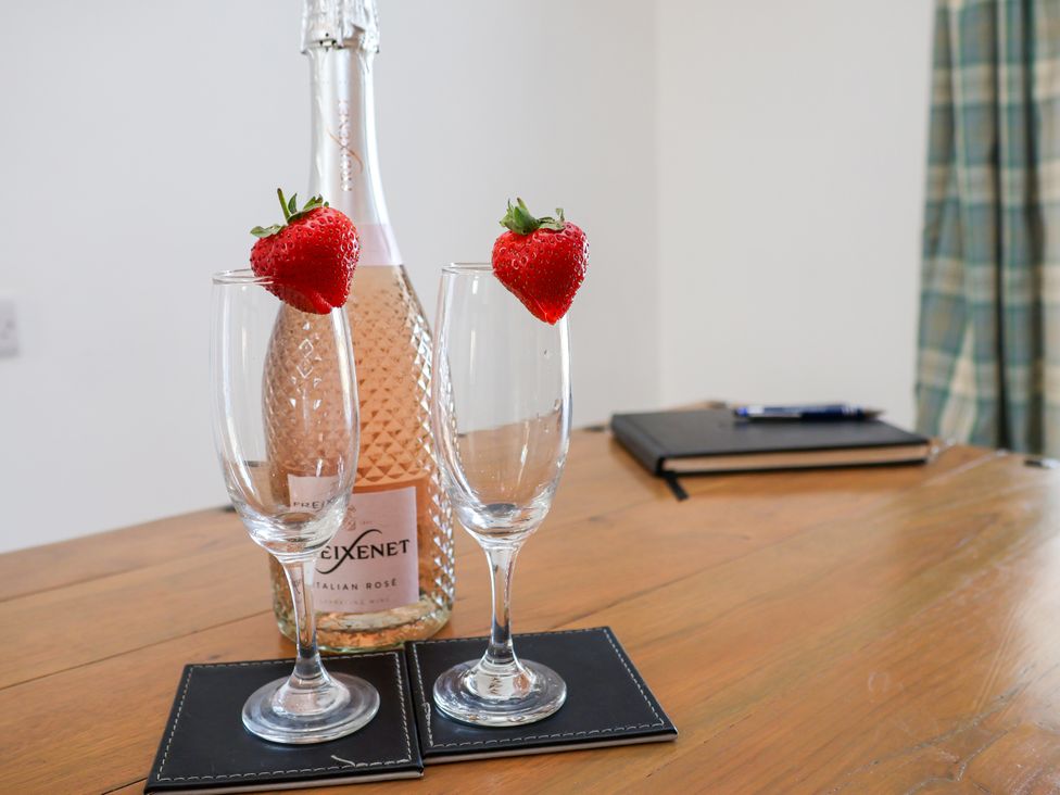 A bottle of Italian rose with two glasses and strawberries at Hawthorn Cottage Silpho near Scalby