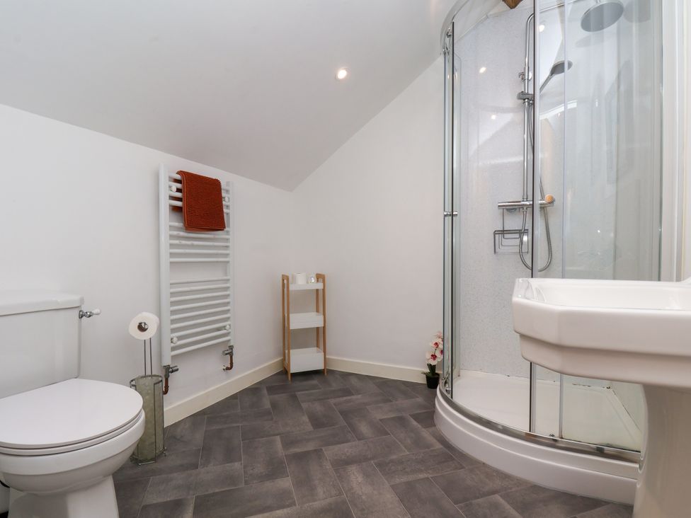 A bathroom with a shower and toilet at Hawthorn Cottage in Silpho near Scalby