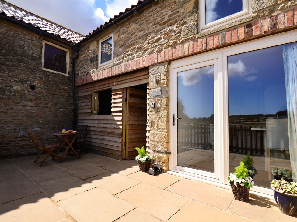 An outdoor area with a table and chairs at Hawthorn Cottage in Silpho near Scalby