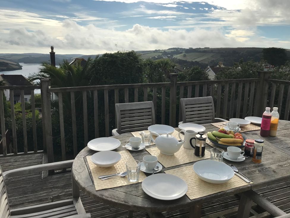 A dining table set with plates and drinks at Firm Anchor in Salcombe