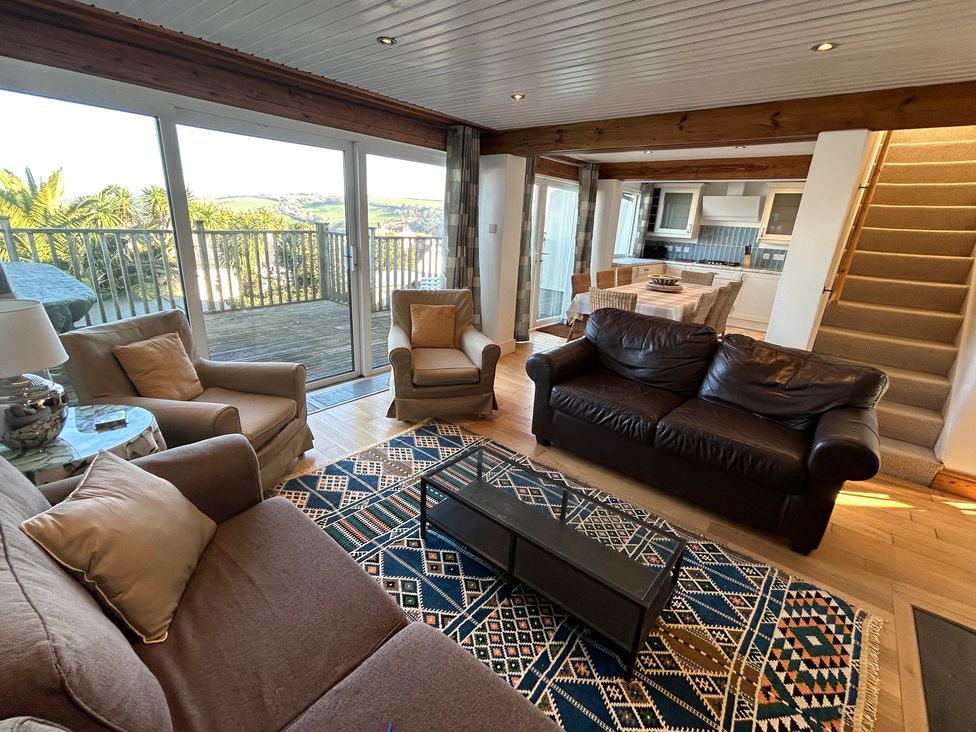 A living room with sofas and a dining area at Firm Anchor in Salcombe