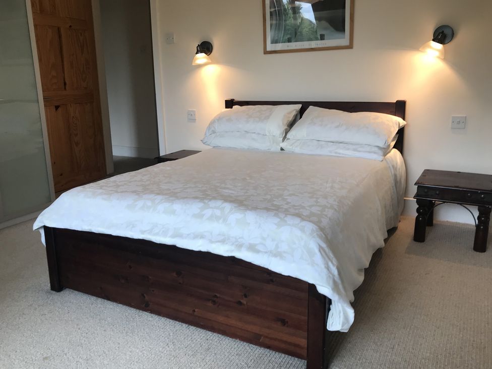 A bedroom with a bed and bedside table at Firm Anchor in Salcombe