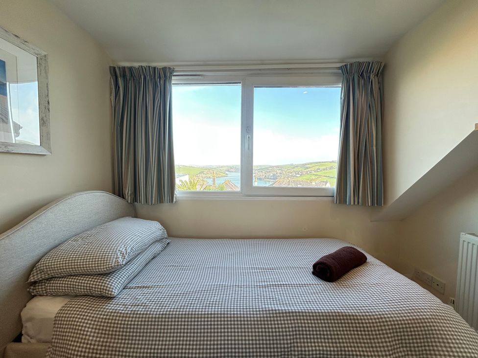 A bedroom with a bed and window at Firm Anchor in Salcombe