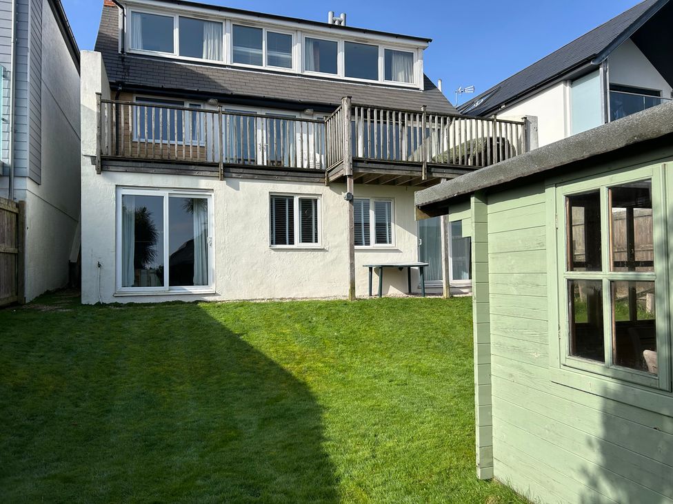 A garden with a house and deck at Firm Anchor in Salcombe
