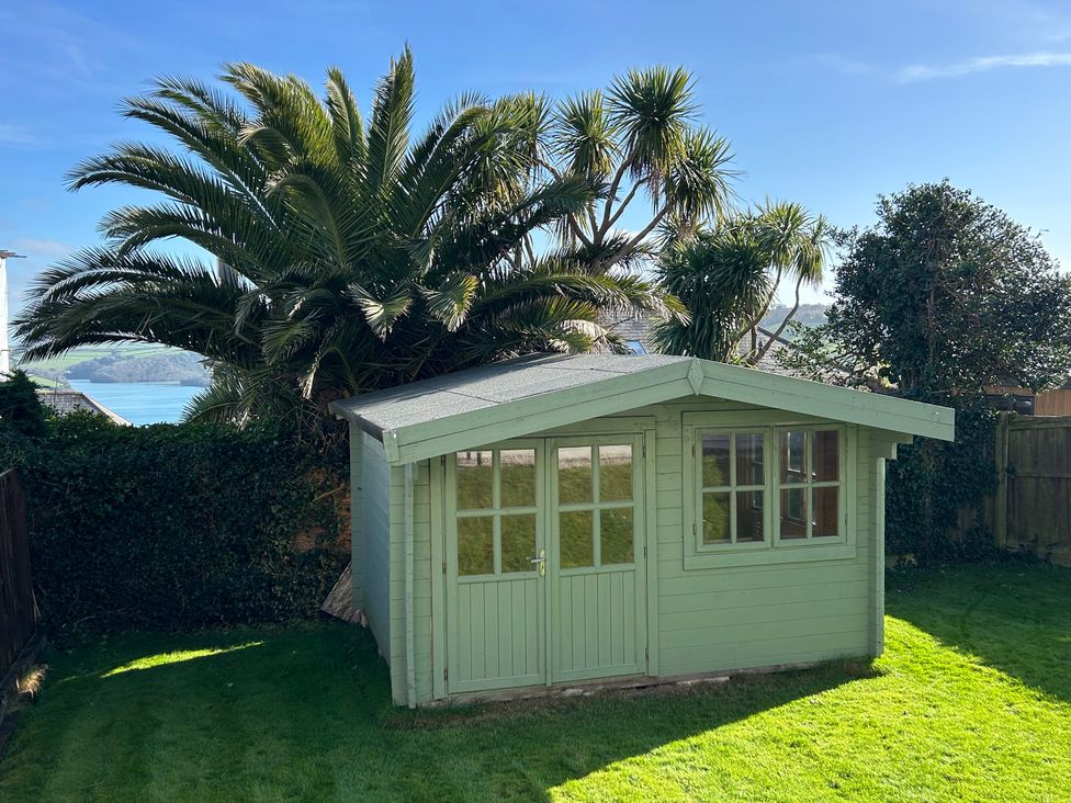 A garden shed surrounded by palm trees at Firm Anchor in Salcombe